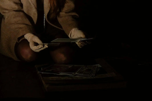 Inspecting a flat cap with raking light for stains, thinning and fraying